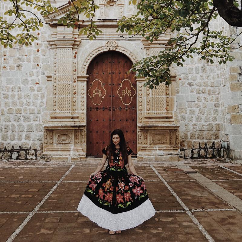Betty Nguyen seated outside a historic church